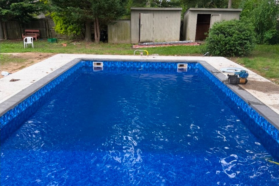Rectangular inground pool filled with water after a new liner installation in Long Island NY