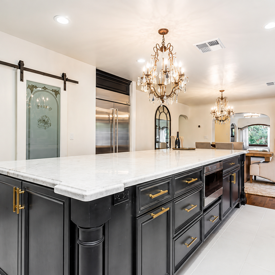 Custom kitchen renovation with black cabinets and marble island by Warehouse Interiors in Fair Oaks, CA