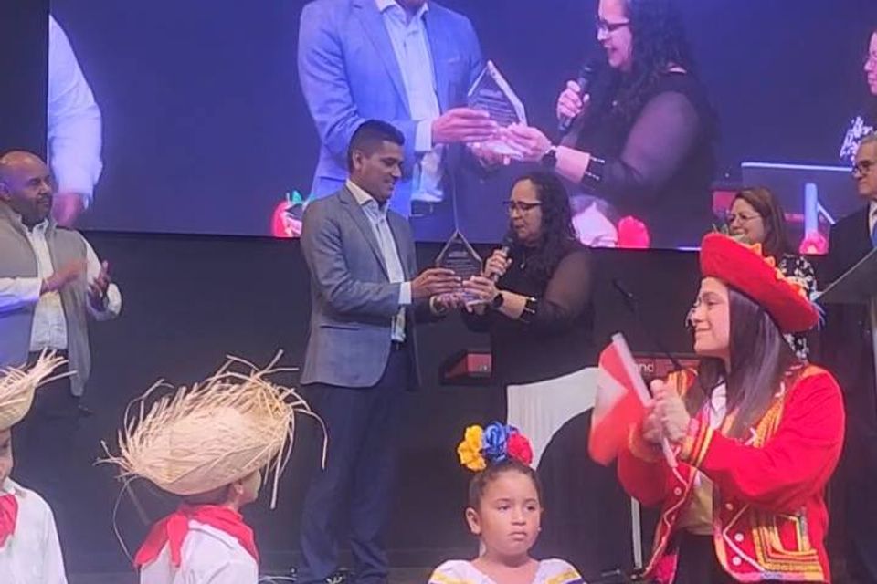 Receiveing recognition award on hispanic heritage month for his support at church and community