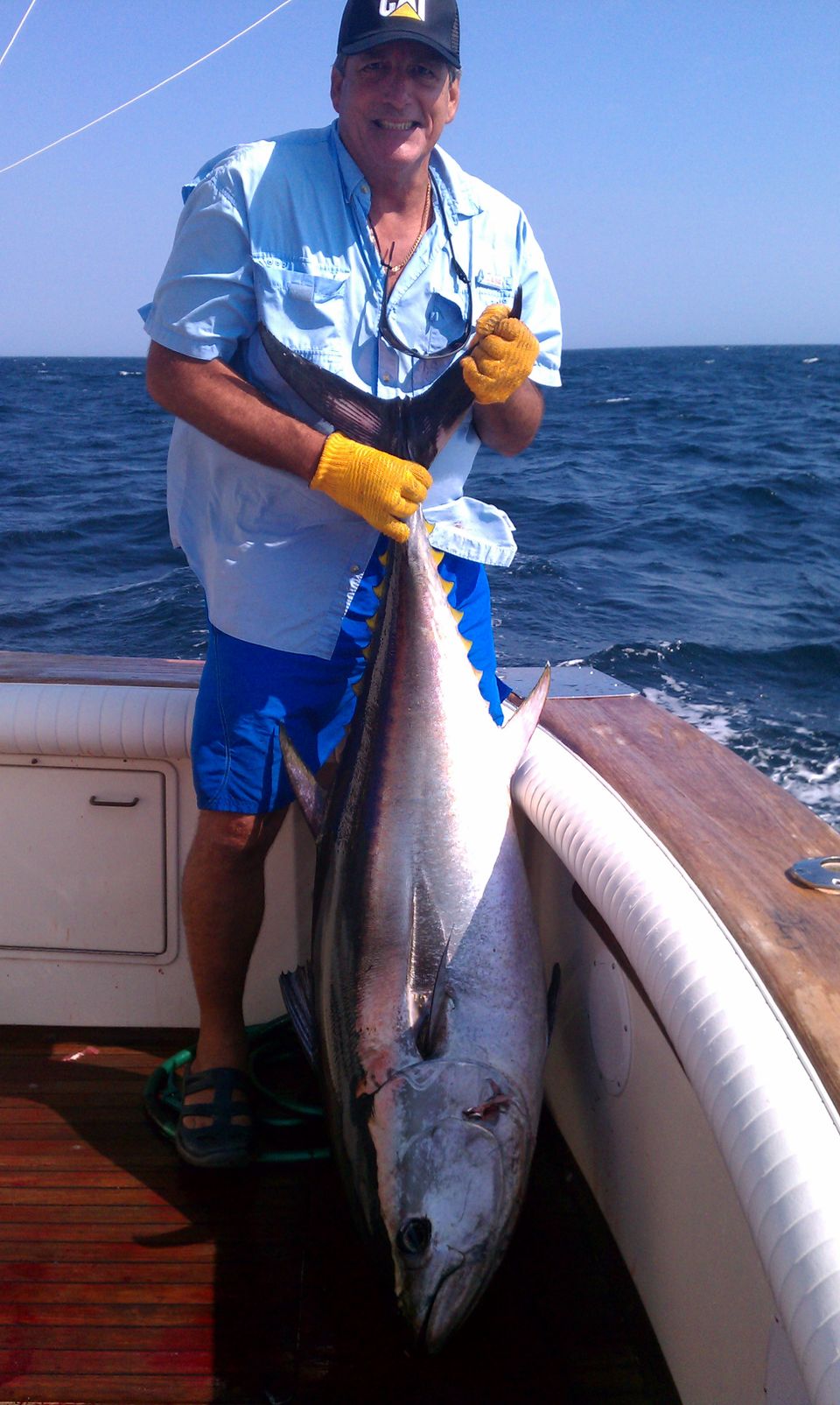 Man on boat holding tuna3