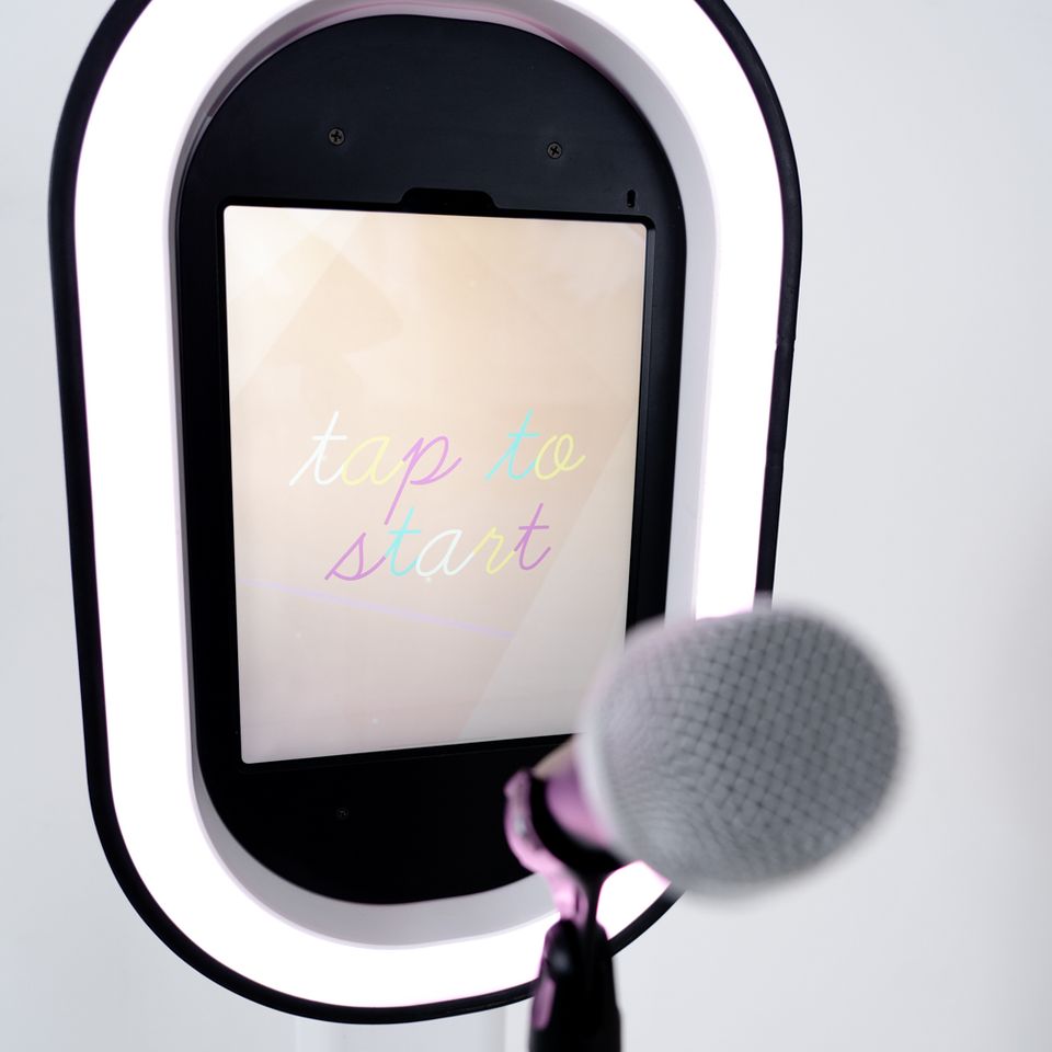 Interactive video guest book station with ring light and microphone for guest recordings.