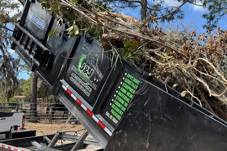 JNJ Hauling Solutions dumpster in the emptying position