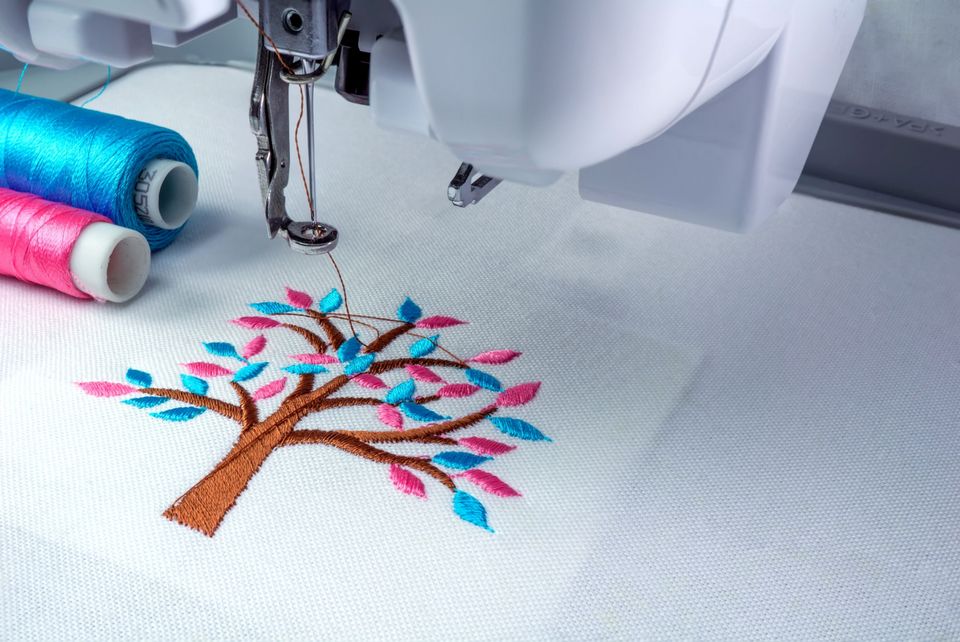 Close up picture embroidery machine two threads cyan pink color