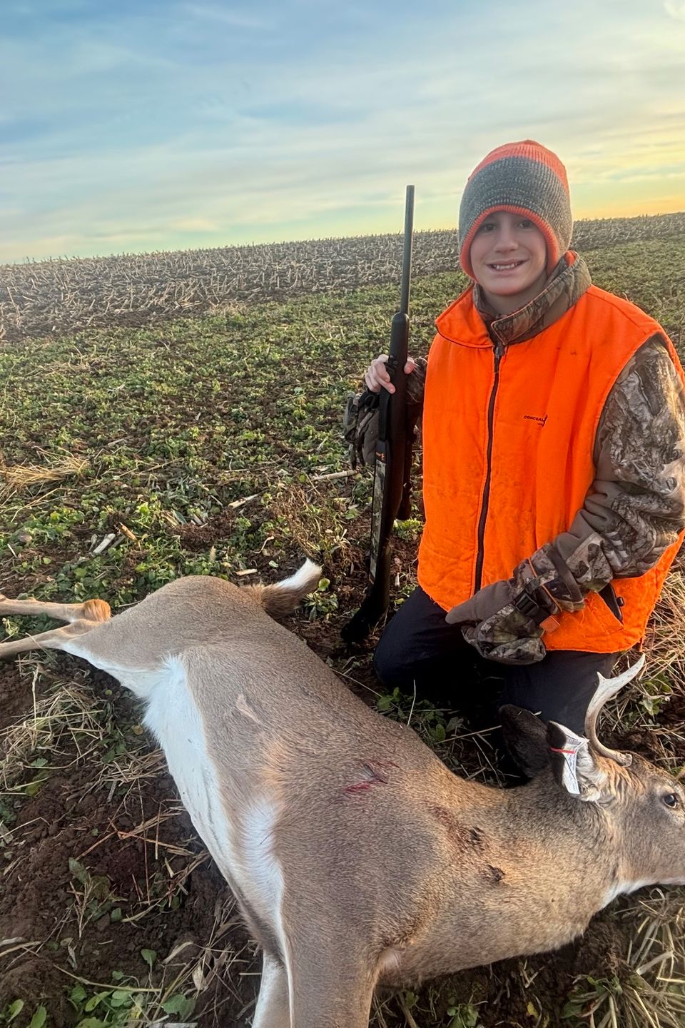 Gabe and his buck. Photo by Jake Boyer