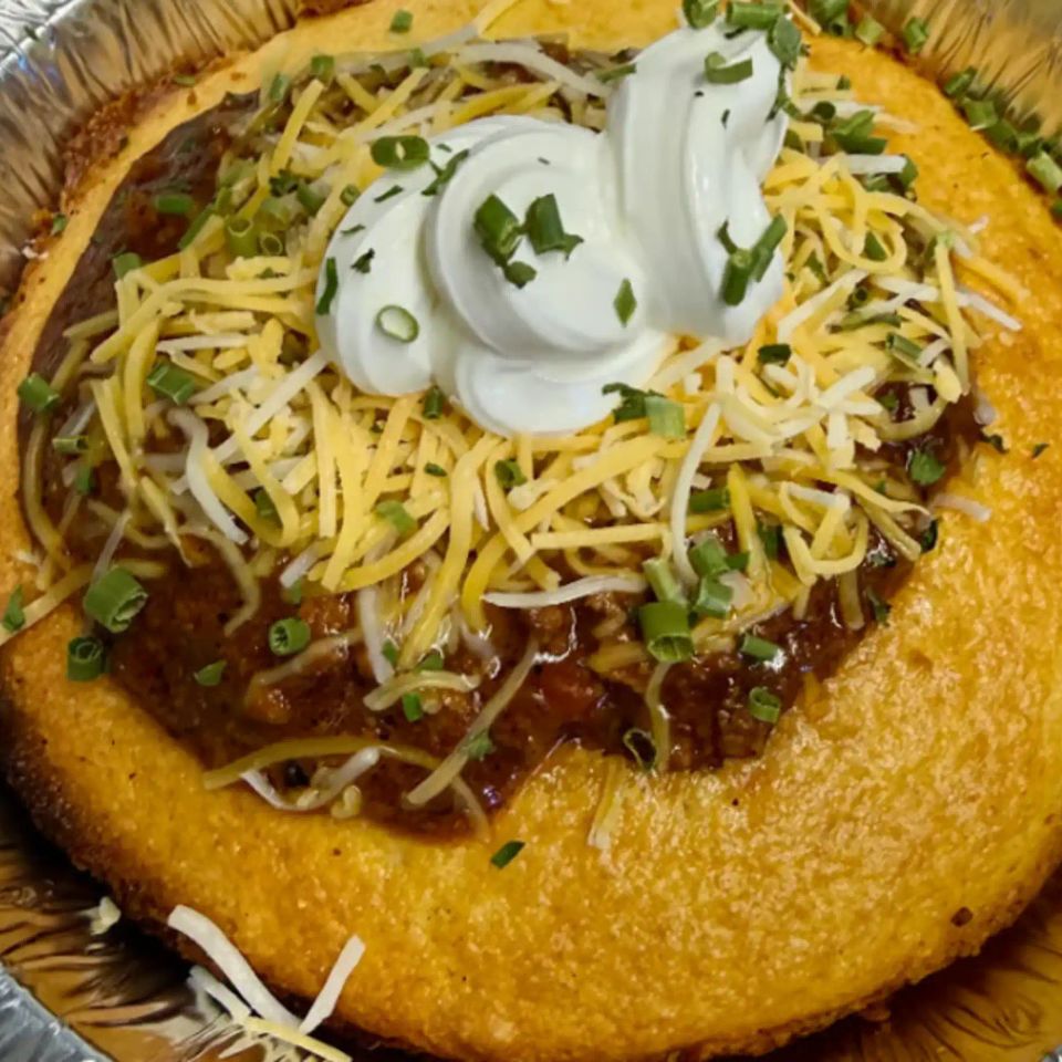 Hearty chili in warm cornbread bowl