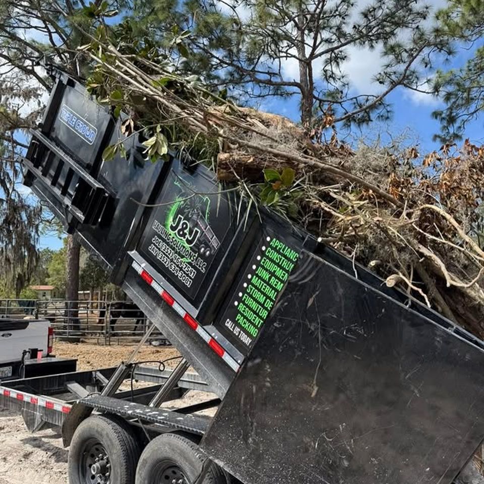 JNJ Hauling Solutions dumpster in the emptying position