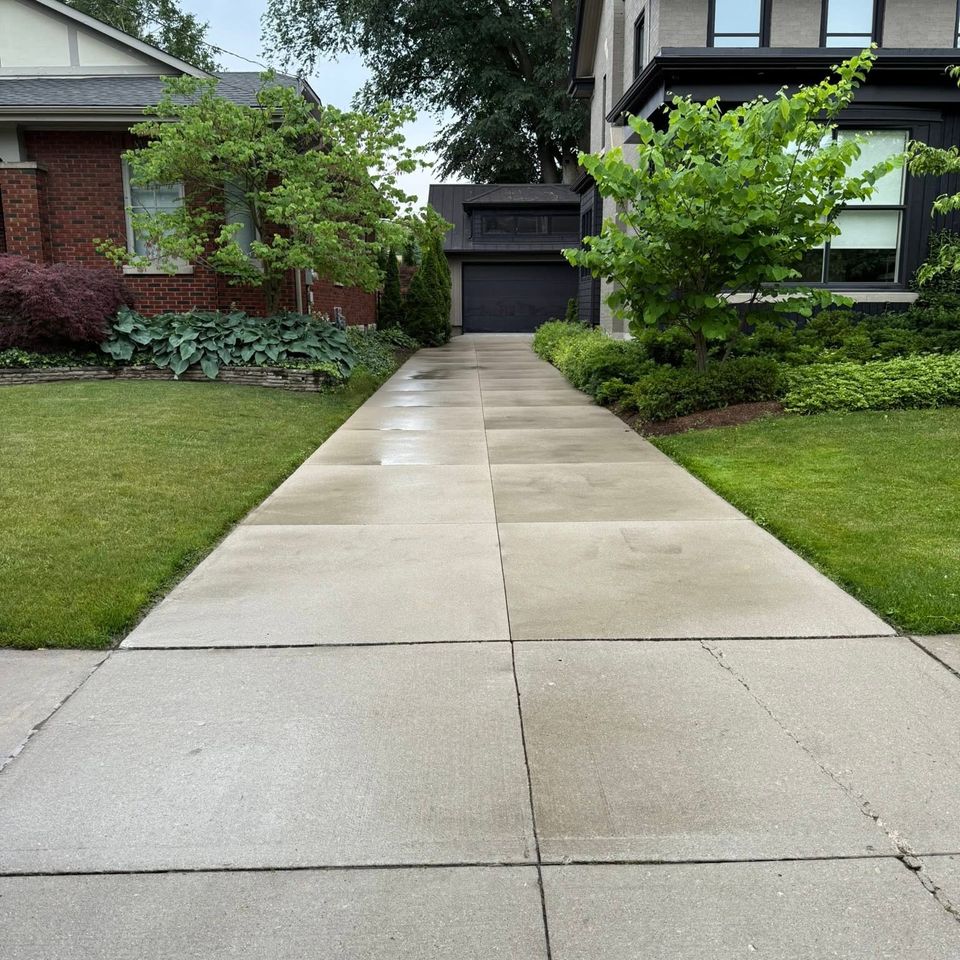Clean concrete driveway and walkway after pressure washing at a residential property in Tillsonburg Ontario
