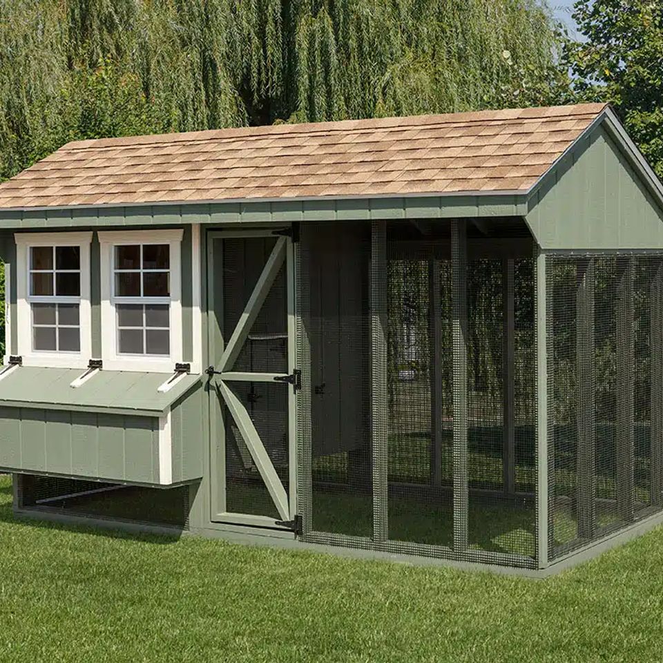 Green Quaker chicken coop with nesting box and wire run installed on a Knoxville TN lawn