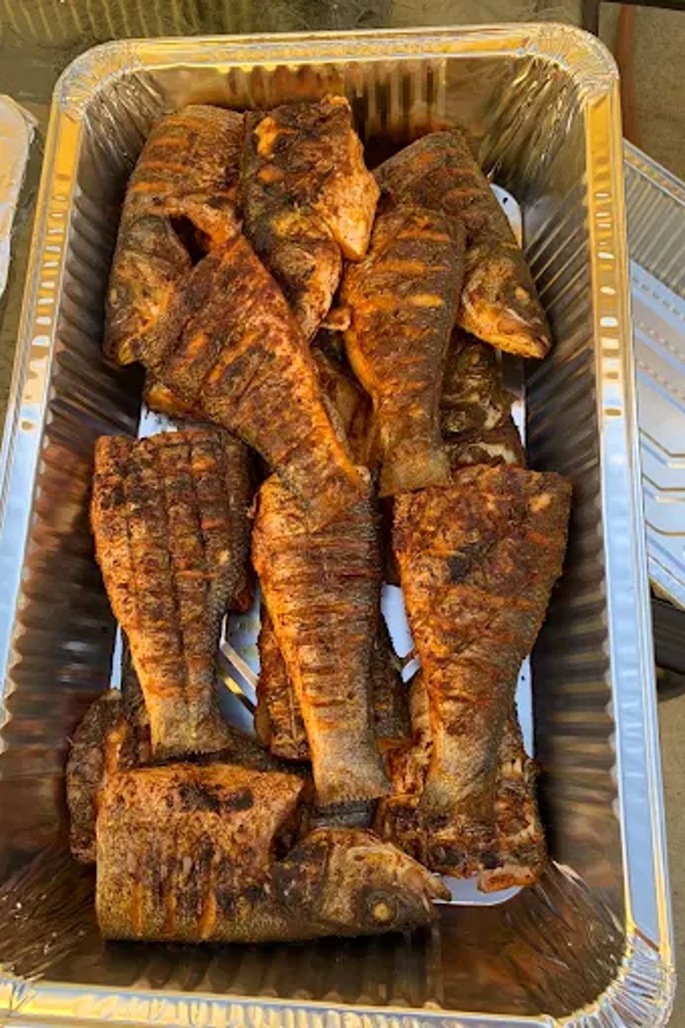 Catering tray of seasoned grilled whole fish prepared for a Los Angeles CA party
