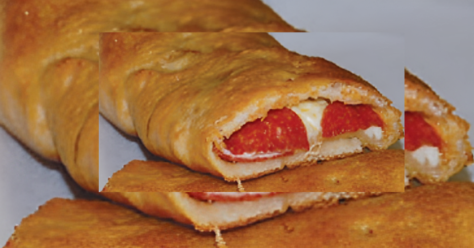 Pepperoni roll filled with pepperoni and melted cheese inside baked dough.