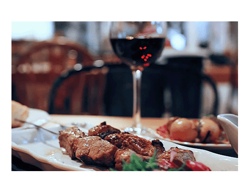 Wine and steak skewers in restaurant
