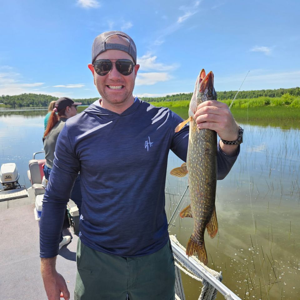 Tom Bender of Palmyra, PA holding a pike he caught while enjoying a day of Alaska fishing.