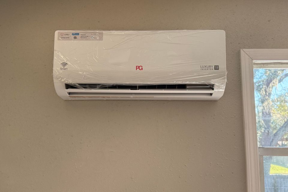 Split unit air conditioner system with indoor air handler and outdoor compressor