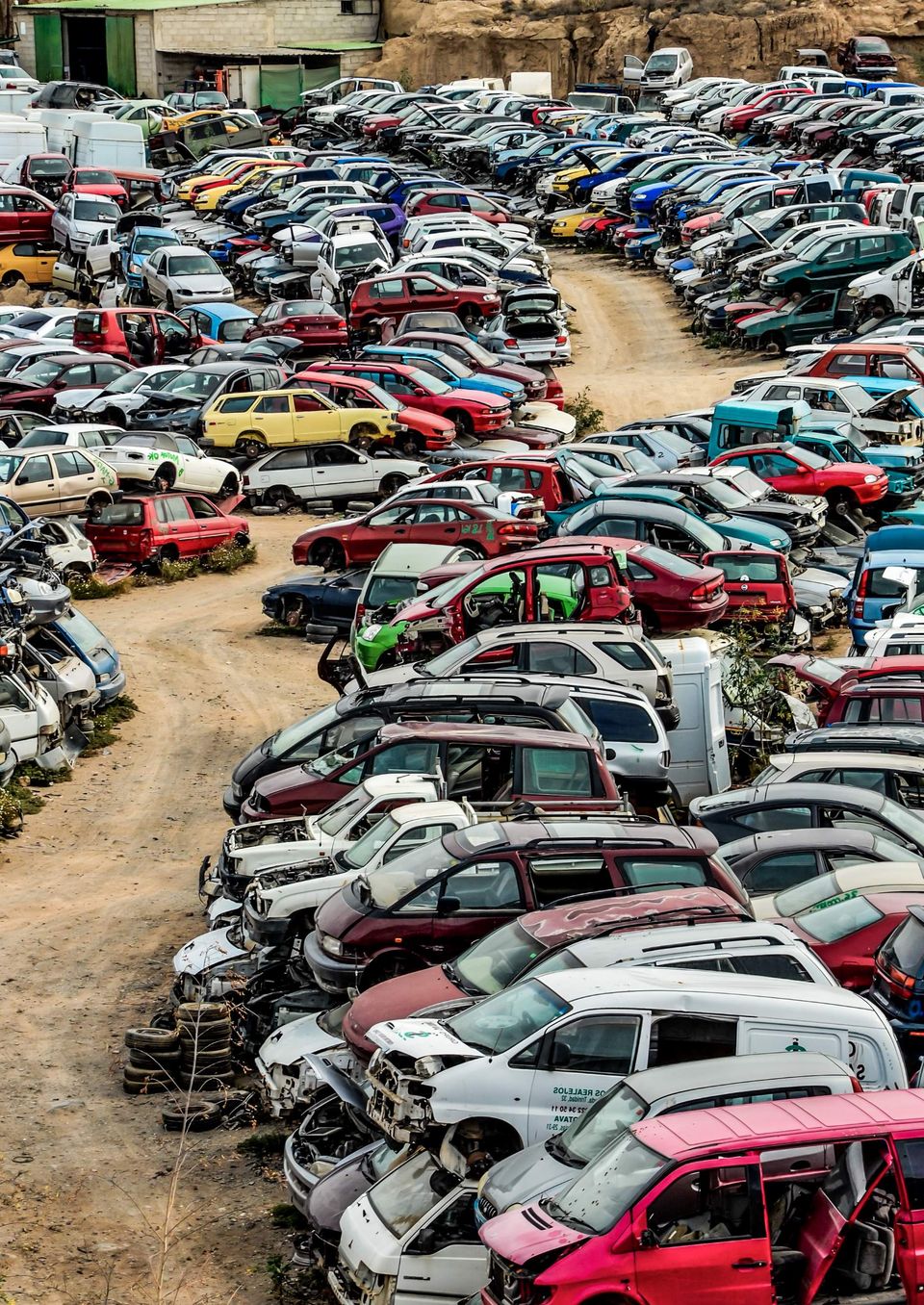Scrap Yard With Pile Of Crushed Cars