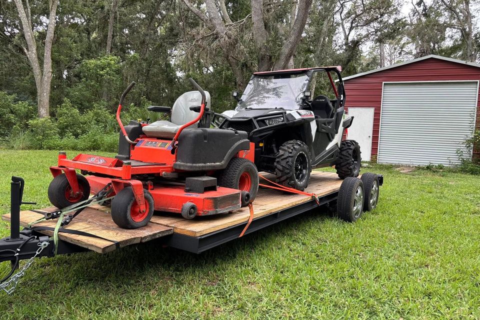 A tractor being hauled by JNJ Hauling Solutions of Citrus County