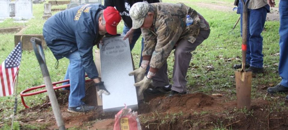 Planting the new grave marker
