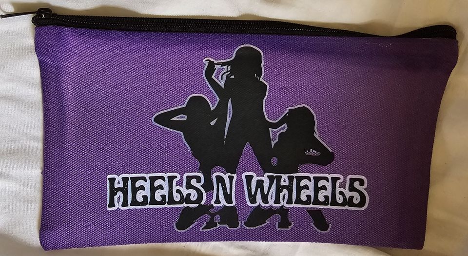 Purple zippered pouch displaying the Heels 'n Wheels logo with silhouetted figures and bold branding.