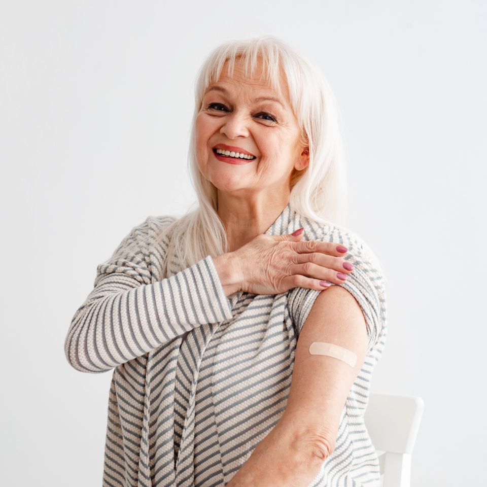 Portrait Of Happy Smiling Woman Showing Vaccinated Shoulder With Patch