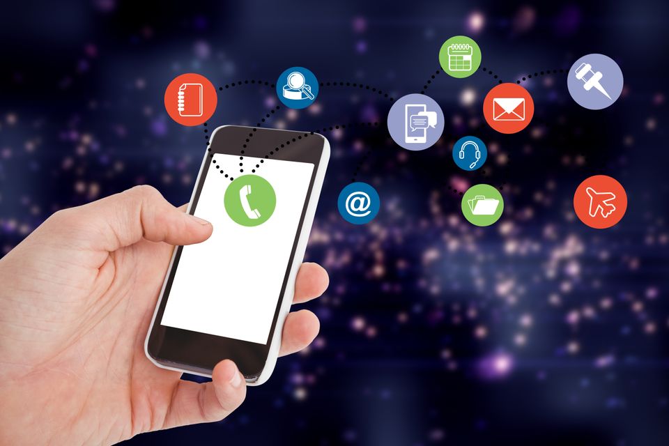 Close up hand holding smartphone with colorful app icons