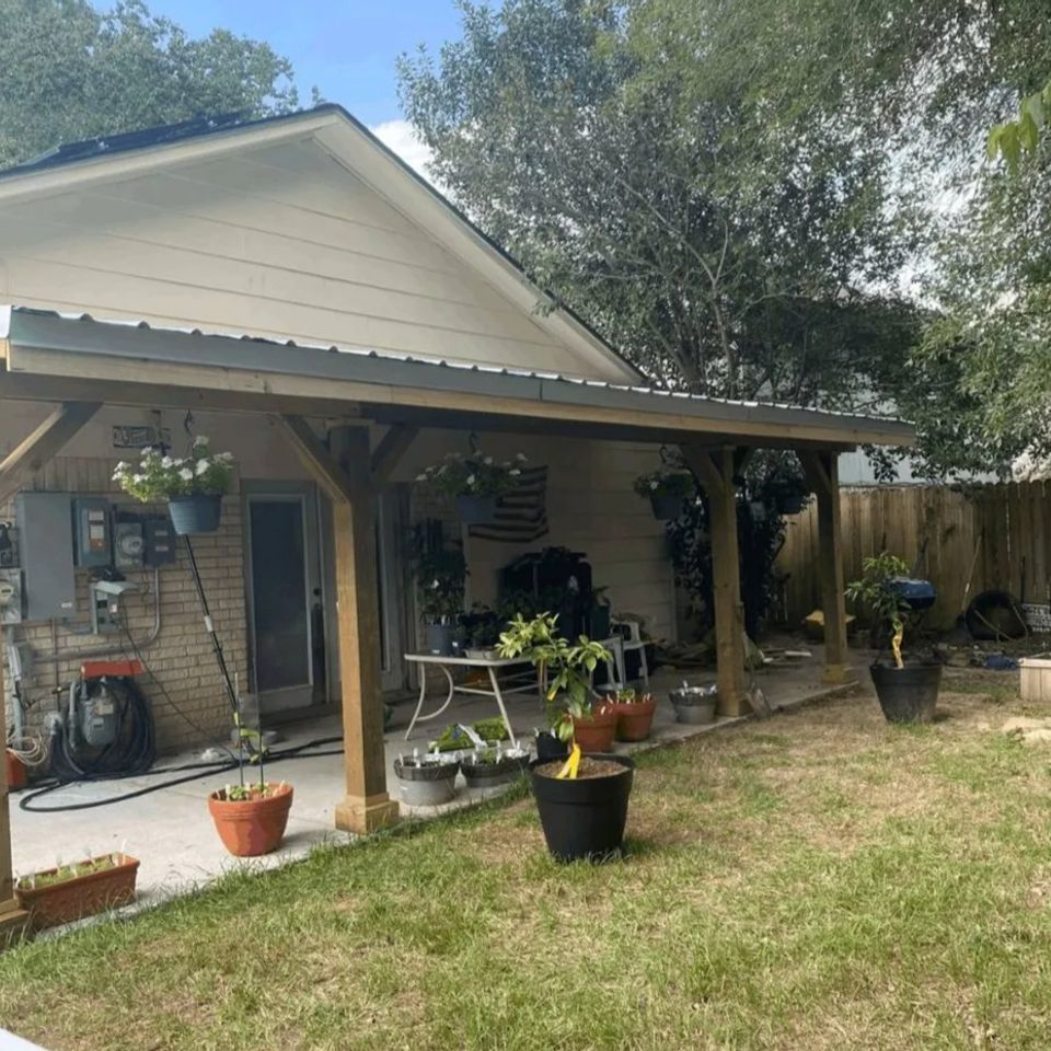Custom Patio Cover with corrugated metal roof and wood support columns by Media Construction in Spring, TX