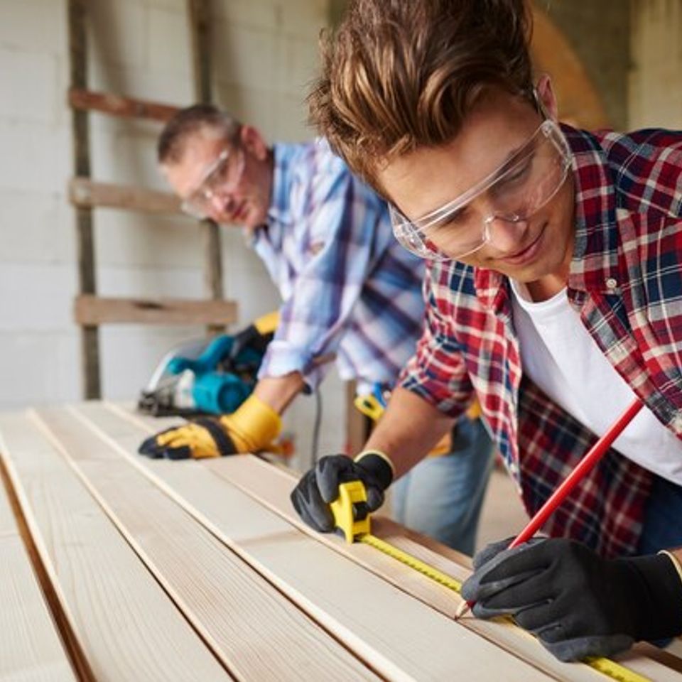 Close up experienced carpenter his younger employee 329181 15687