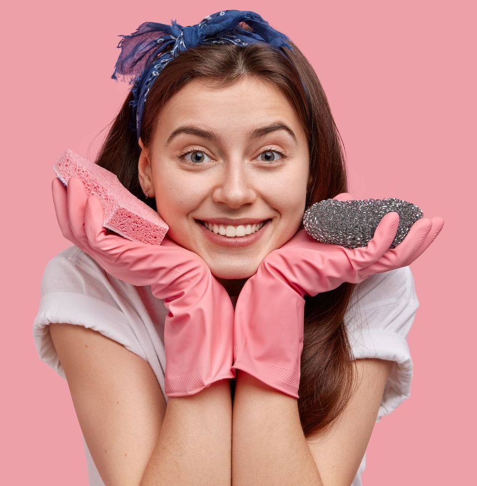 Young woman posing with cleaning products c