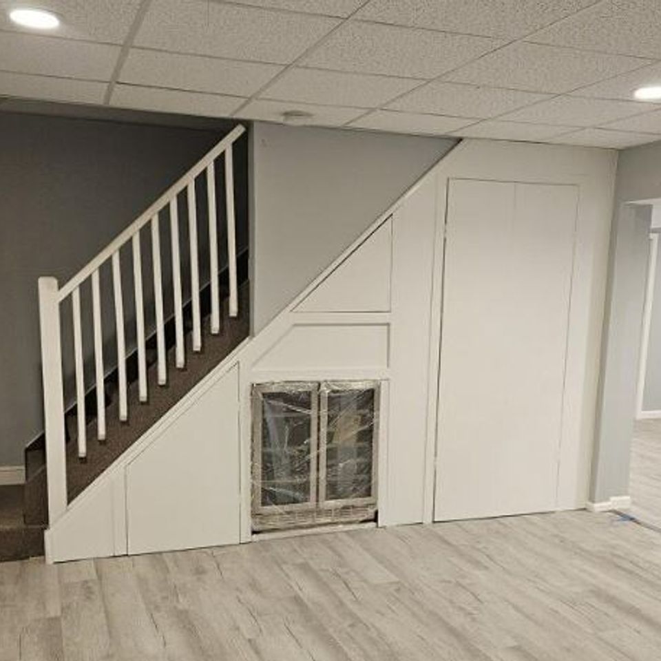 Finished basement with custom under stair built ins by general contractor in Suffolk County NY