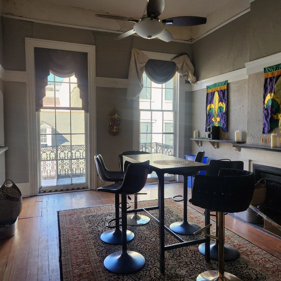 232 Bourbon Street Balcony with large front room with high tables and chairs