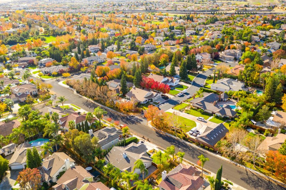 Aerial drone view of Roseville, California, showcasing master-planned residential neighborhoods, luxury shopping centers, and the extensive urban forest canopy of Placer County.