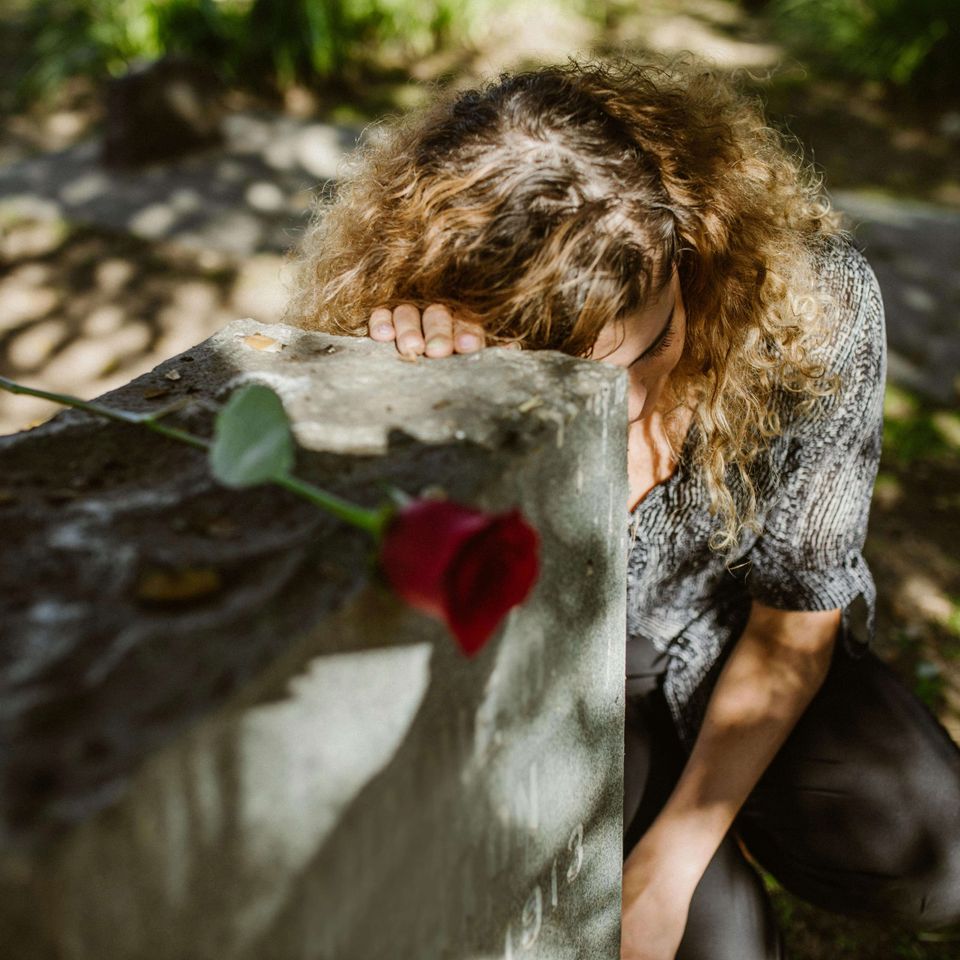 Woman Grieving at headstone Grief Counseling