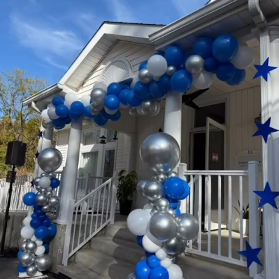 alt="The Party Savers staff bartending and waitressing at a Grand Opening event"