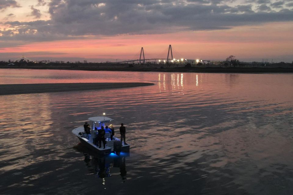 Small group on boat during Charleston sunset with Ravenel Bridge in background