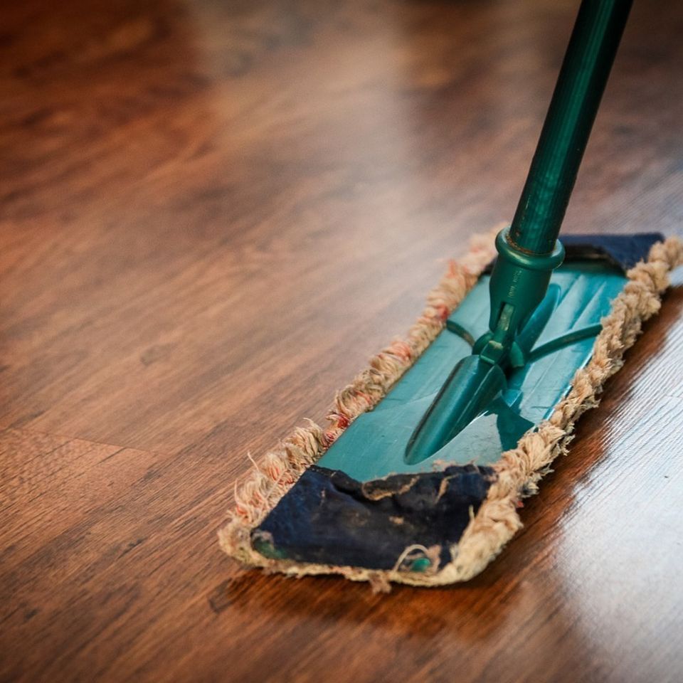 mop on wooden panel floor