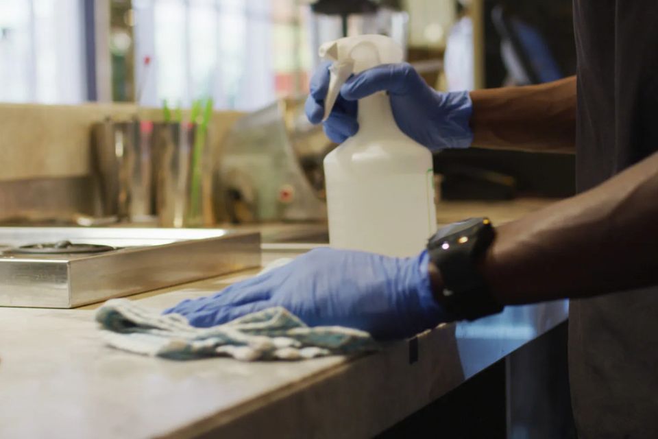 Office cleaning crew sanitizing a sink