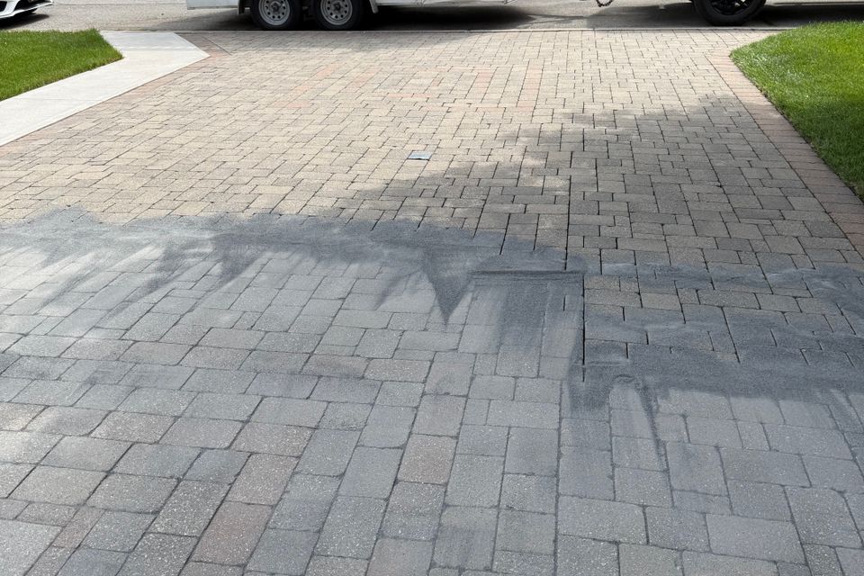 Polymeric sand swept into interlock driveway pavers after interlock cleaning with Elevation Exteriors trailer in Tillsonburg ON