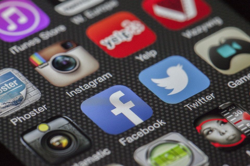 cell phone screen with social media app logos