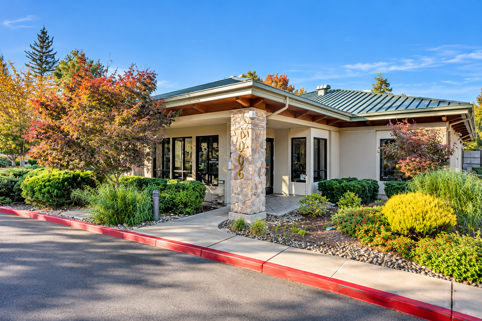 Modern clubhouse entrance with stone address pillar