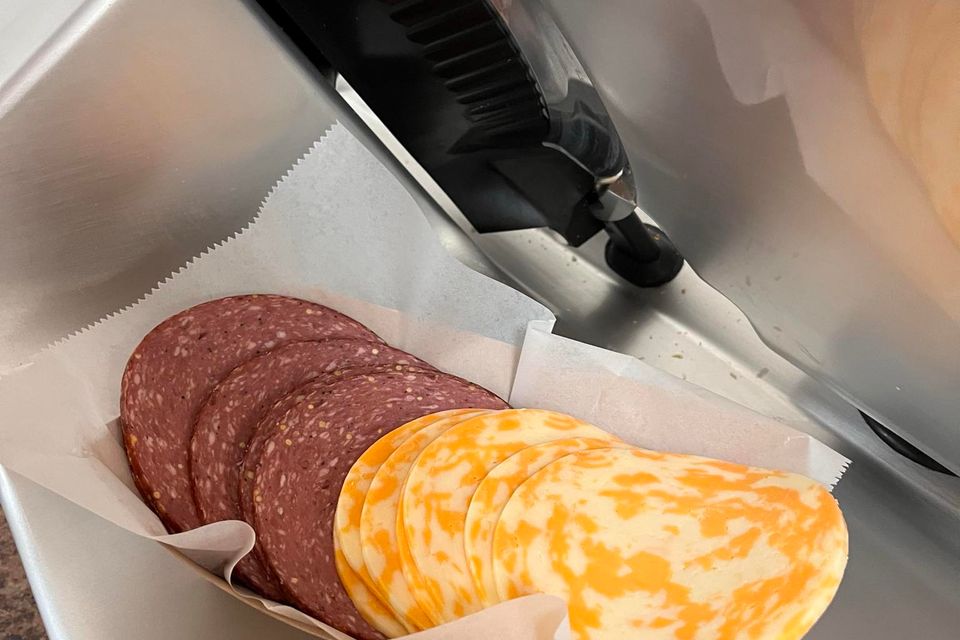 Sliced summer sausage and colby cheese