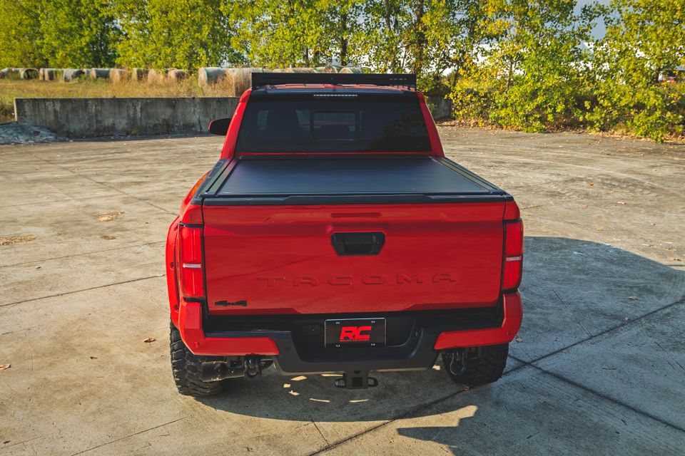 Red Toyota Tacoma with bed cover