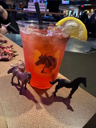 Red Kentucky Derby-themed cocktail with lemon garnish served at JR's during the 2025 event.