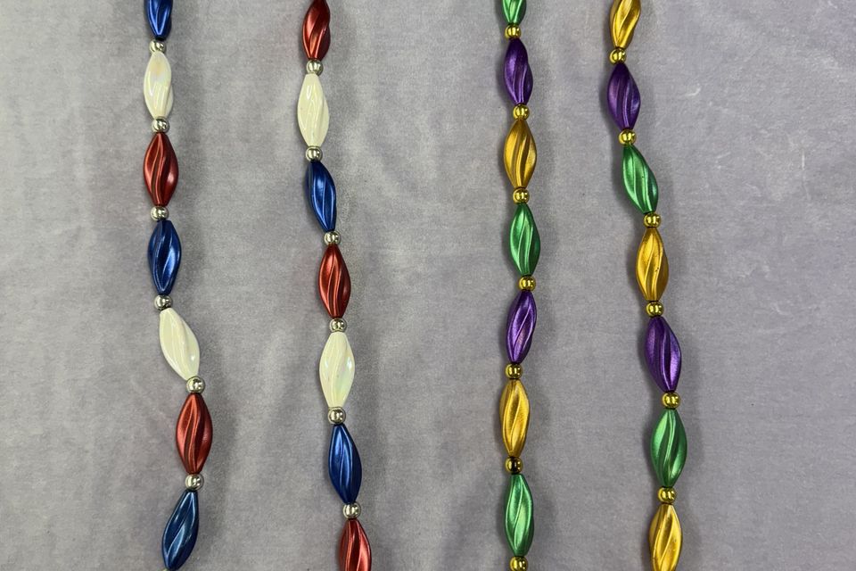 Two pairs of beads Red, white, and blue and purple, green and gold.