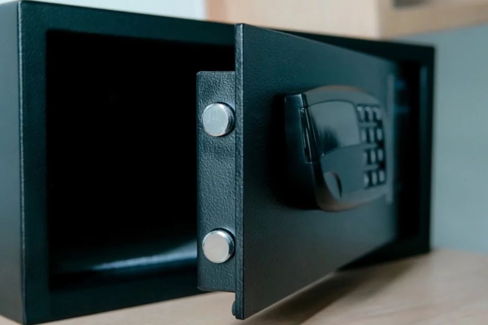 Opened small safe with visible deadbolts, showcasing secure lock and safe mechanisms.