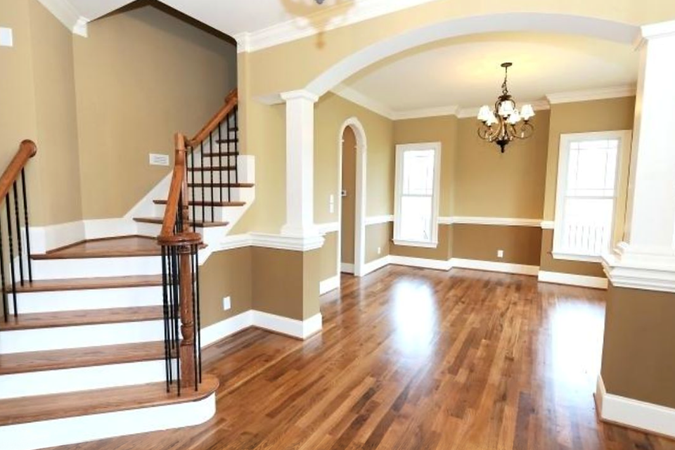 Tan entryway curved staircase hardwood