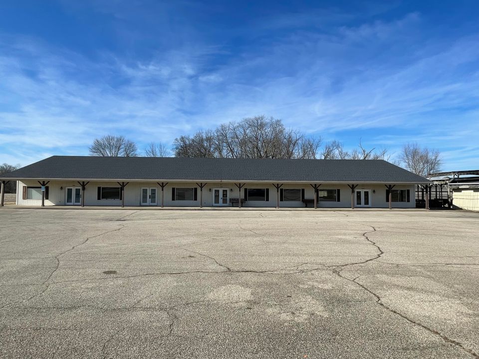 Large commercial building featuring a professionally installed low-slope roofing system by E & D Roofing, Inc.