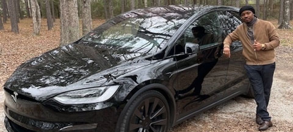 Abner shotwell with black tesla   casual min