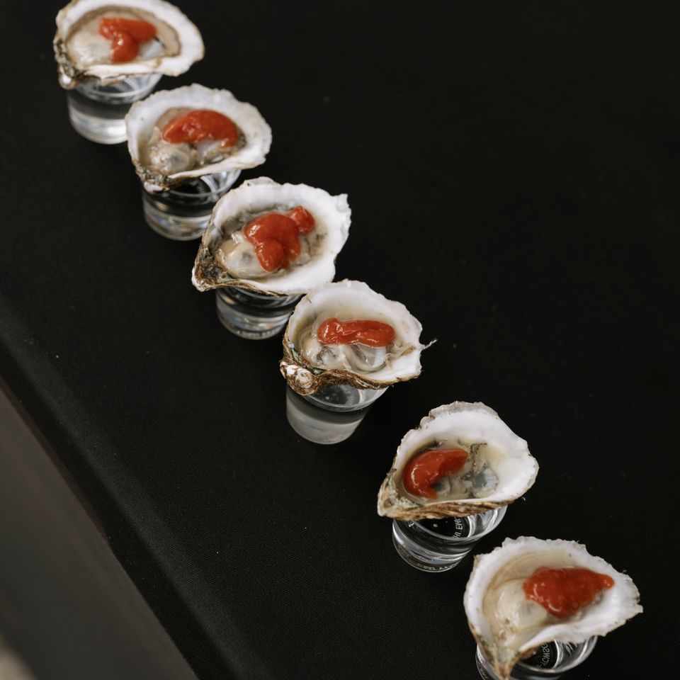 Oysters with shot glasses, catered by Shore2Shore Shucking of Long Island
