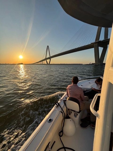View of Ravenel Bridge at sunset from boat tour in Charleston Harbor