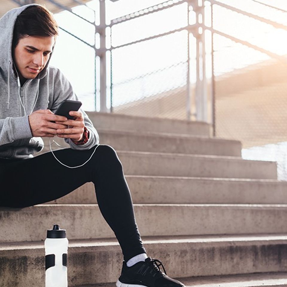 Athlete checking phone in stands