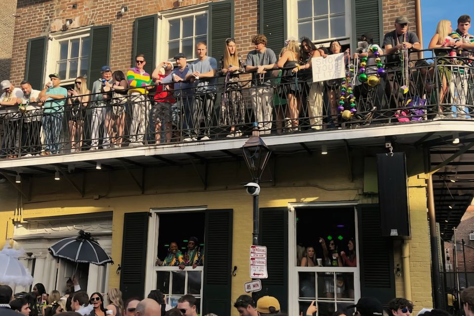 VIP Mardi Gras balcony at The Swamp 516 Bourbon Street overlooking the Bourbon Street crowds in New Orleans