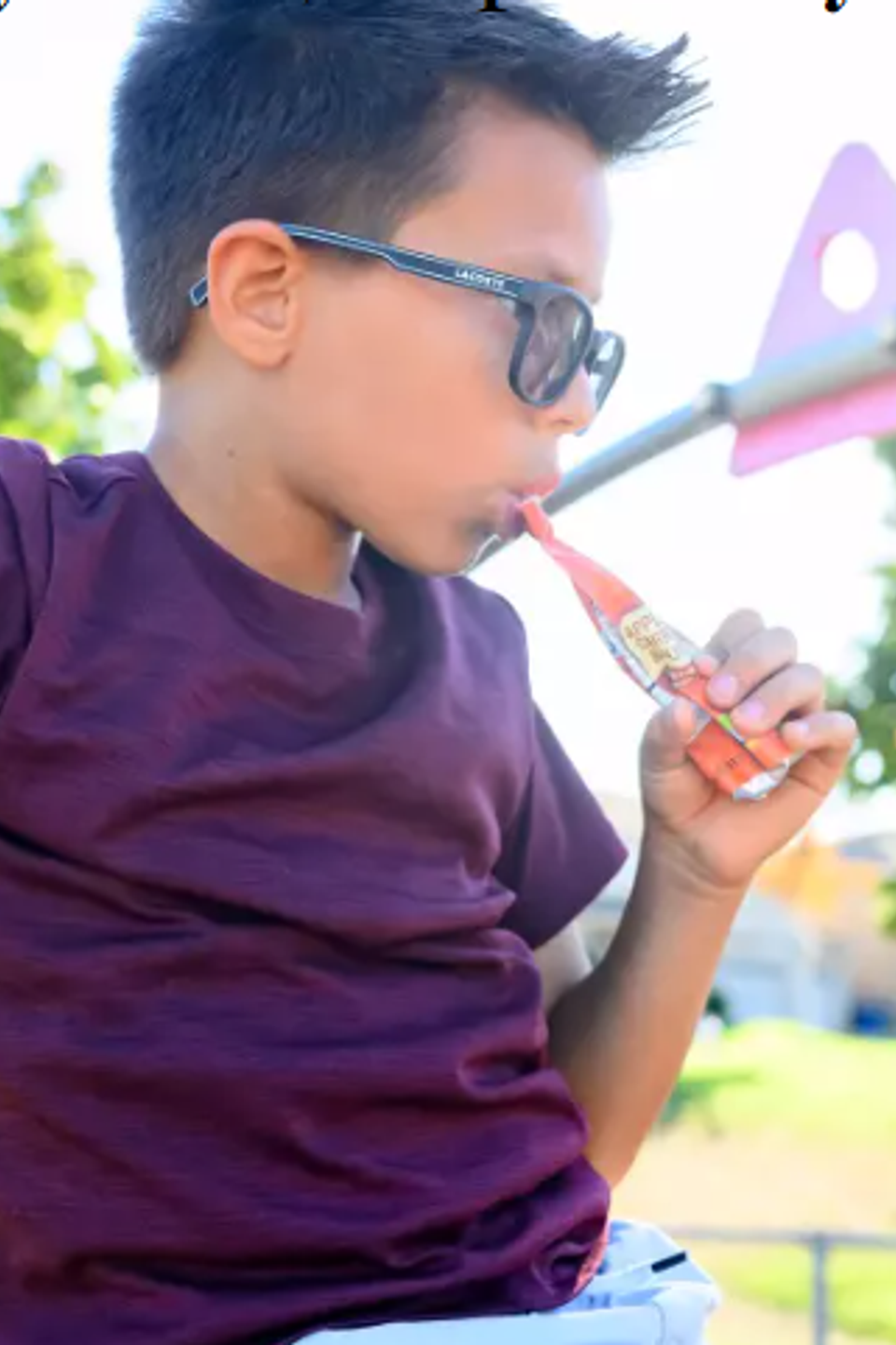 Kid eating yogurt from pouch